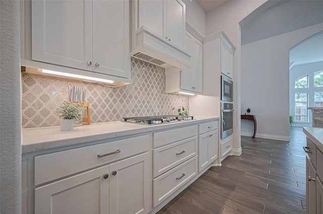 2430 Sunflower Cove Ln, Brookshire, TX 77423 - kitchen with stainless steel appliances, arched walkways, dark wood-type flooring, and light countertops