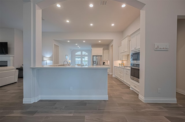 2430 Sunflower Cove Ln, Brookshire, TX 77423 - kitchen with stainless steel appliances, white cabinetry, recessed lighting, a peninsula, and dark wood finished floors