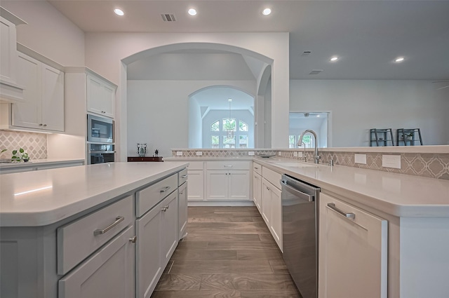 2430 Sunflower Cove Ln, Brookshire, TX 77423 - kitchen featuring appliances with stainless steel finishes, a kitchen island, light countertops, backsplash, and recessed lighting