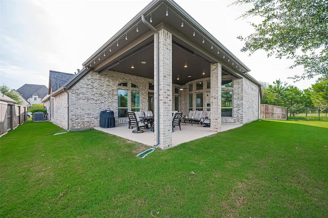2430 Sunflower Cove Ln, Brookshire, TX 77423 - rear view of property with brick siding, a patio, and a fenced backyard