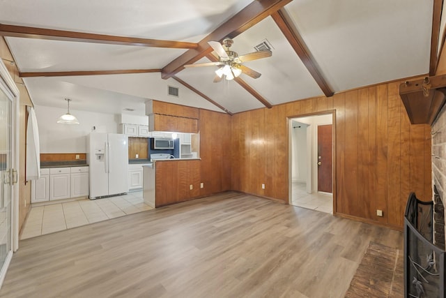 746 Fawn Dr, Houston, TX 77015 - unfurnished living room with light wood-style floors, ceiling fan, and wooden walls