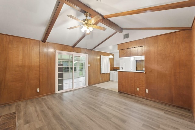 746 Fawn Dr, Houston, TX 77015 - unfurnished living room with ceiling fan, wood walls, and light wood finished floors