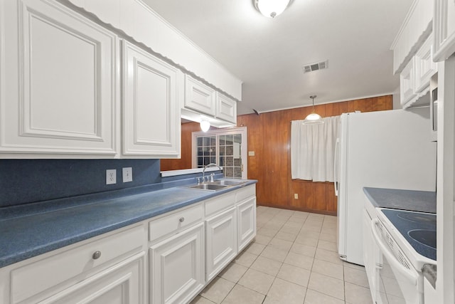 746 Fawn Dr, Houston, TX 77015 - kitchen with electric range, wooden walls, dark countertops, white cabinetry, and light tile patterned flooring