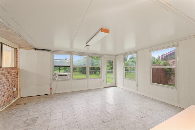 746 Fawn Dr, Houston, TX 77015 - unfurnished sunroom with tile patterned flooring and brick wall