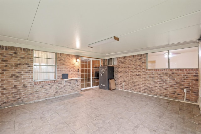 746 Fawn Dr, Houston, TX 77015 - unfurnished living room featuring brick wall and tile patterned floors