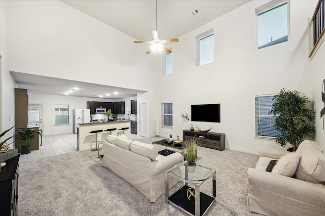 1516 Foshee Ct, Alvin, TX 77511 - living area featuring a high ceiling, ceiling fan, and light carpet
