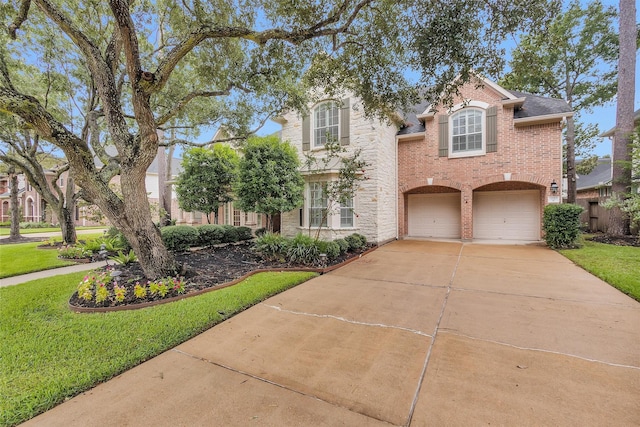 14015 Halprin Creek Dr, Cypress, TX 77429 - view of front facade with brick siding, concrete driveway, a garage, and a front lawn