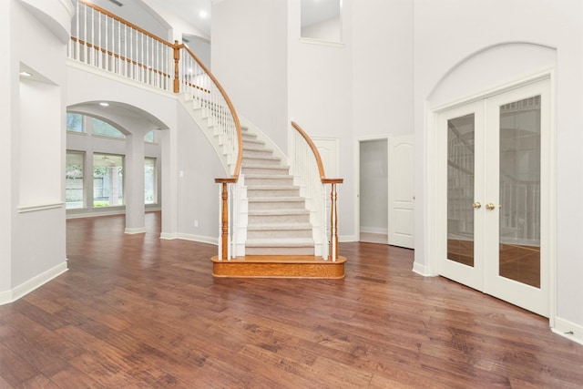 14015 Halprin Creek Dr, Cypress, TX 77429 - foyer with french doors, arched walkways, a towering ceiling, wood finished floors, and stairway
