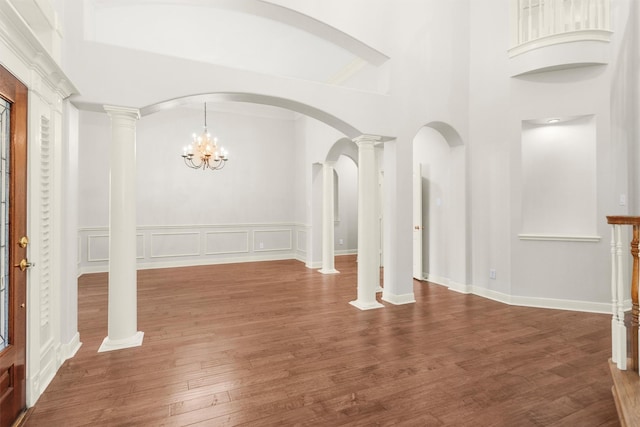 14015 Halprin Creek Dr, Cypress, TX 77429 - entrance foyer with wood finished floors, arched walkways, and decorative columns