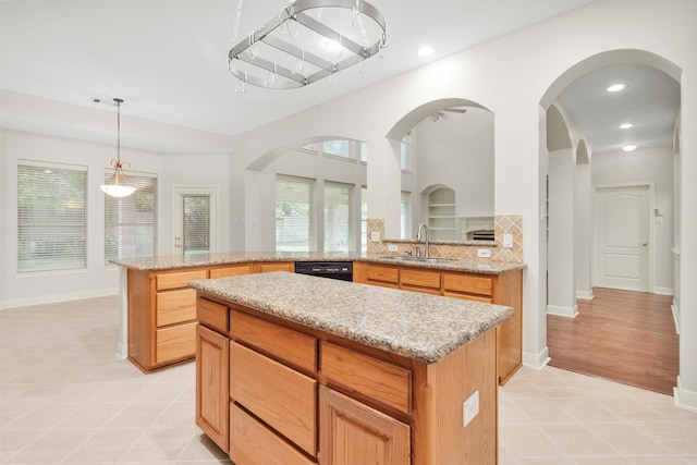 14015 Halprin Creek Dr, Cypress, TX 77429 - kitchen with a center island, dishwasher, light stone counters, decorative light fixtures, and a peninsula