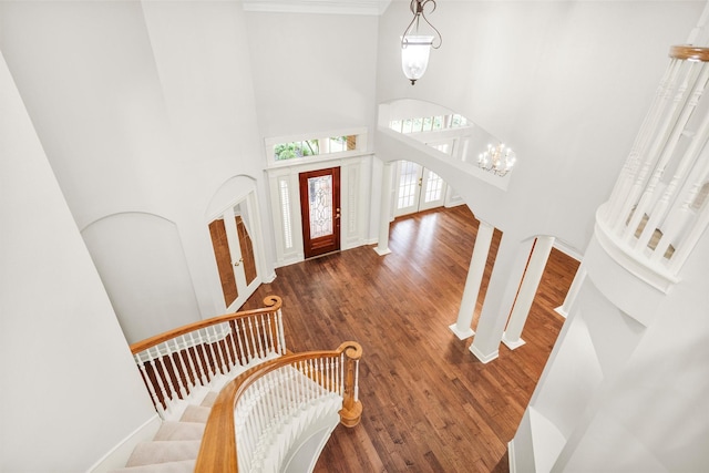 14015 Halprin Creek Dr, Cypress, TX 77429 - foyer entrance with a towering ceiling, wood finished floors, arched walkways, stairway, and crown molding