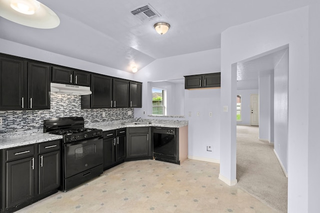 15819 Nutcracker Ct, Humble, TX 77396 - kitchen with black appliances, under cabinet range hood, lofted ceiling, decorative backsplash, and dark cabinets
