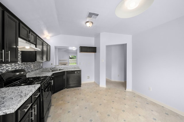 15819 Nutcracker Ct, Humble, TX 77396 - kitchen with black appliances, vaulted ceiling, under cabinet range hood, dark cabinets, and tasteful backsplash