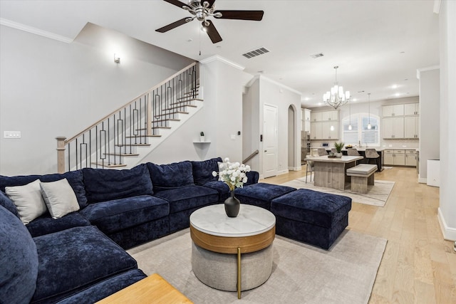 846 Dunleigh Meadows Ln, Houston, TX 77055 - living area featuring a ceiling fan, a chandelier, light wood finished floors, ornamental molding, and arched walkways