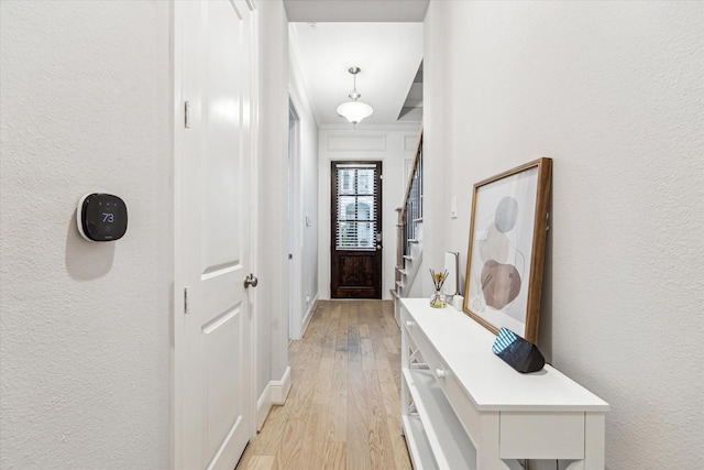 846 Dunleigh Meadows Ln, Houston, TX 77055 - entryway with light wood finished floors, a textured wall, and stairway