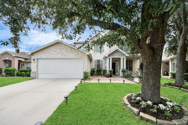 7619 Park Sage Ln, Cypress, TX 77433 - view of front of home featuring a garage, a front yard, driveway, and stone siding