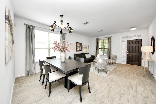 7619 Park Sage Ln, Cypress, TX 77433 - dining area with a chandelier and light wood finished floors
