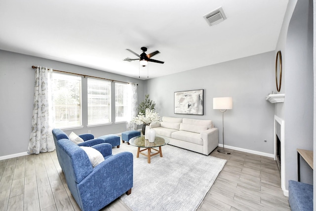 7619 Park Sage Ln, Cypress, TX 77433 - living area featuring a fireplace, ceiling fan, and wood finished floors