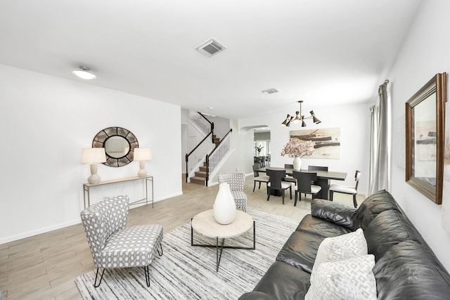 7619 Park Sage Ln, Cypress, TX 77433 - living room featuring arched walkways, stairway, wood finished floors, and a chandelier