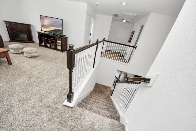 7619 Park Sage Ln, Cypress, TX 77433 - stairway featuring carpet, attic access, and a glass covered fireplace