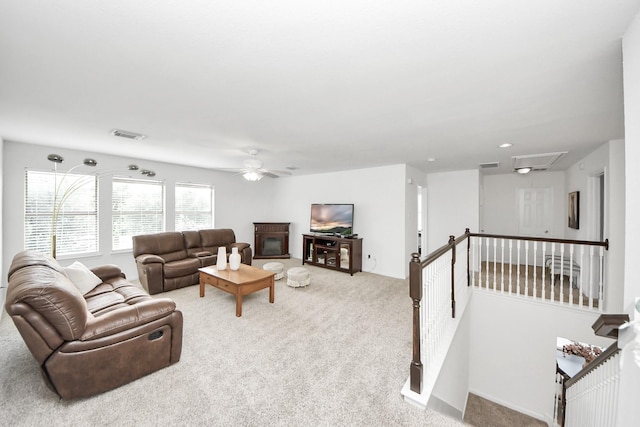 7619 Park Sage Ln, Cypress, TX 77433 - carpeted living room featuring ceiling fan, a glass covered fireplace, and attic access