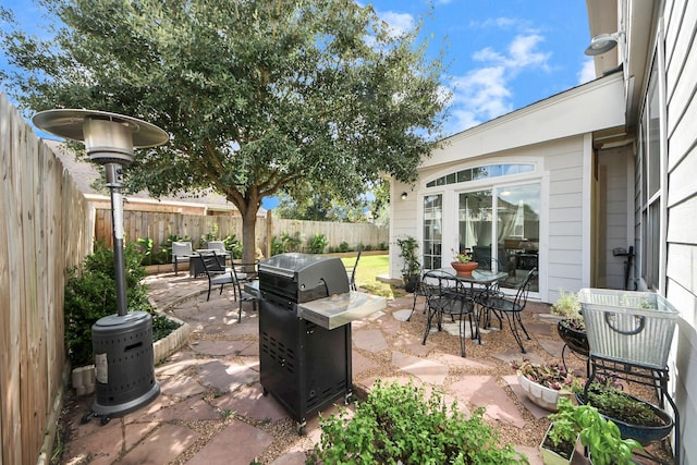 7619 Park Sage Ln, Cypress, TX 77433 - fenced backyard featuring grilling area, a patio area, and outdoor dining area