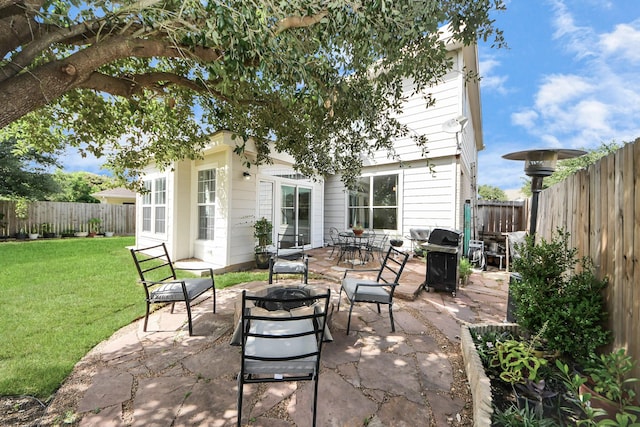 7619 Park Sage Ln, Cypress, TX 77433 - fenced backyard featuring an outdoor fire pit, a grill, and a patio