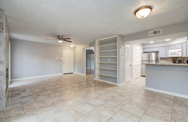 10555 Turtlewood Ct Unit 2802, Houston, TX 77072 - unfurnished living room featuring ceiling fan and a textured ceiling