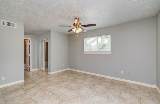 10555 Turtlewood Ct Unit 2802, Houston, TX 77072 - spare room featuring ceiling fan, tile patterned floors, and a textured ceiling