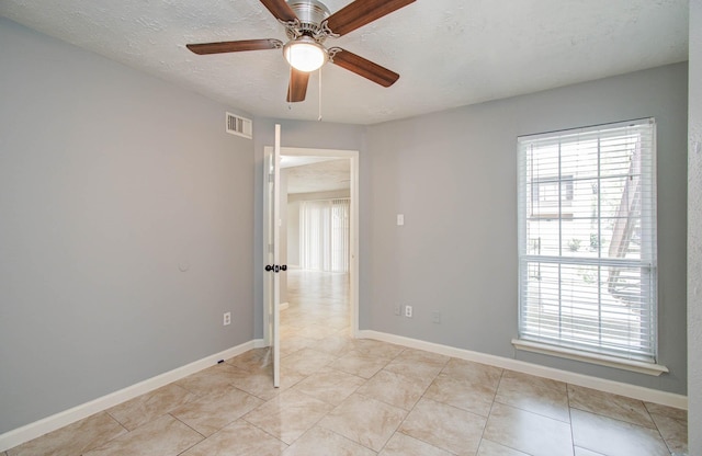 10555 Turtlewood Ct Unit 2802, Houston, TX 77072 - empty room with plenty of natural light, ceiling fan, and light tile patterned floors
