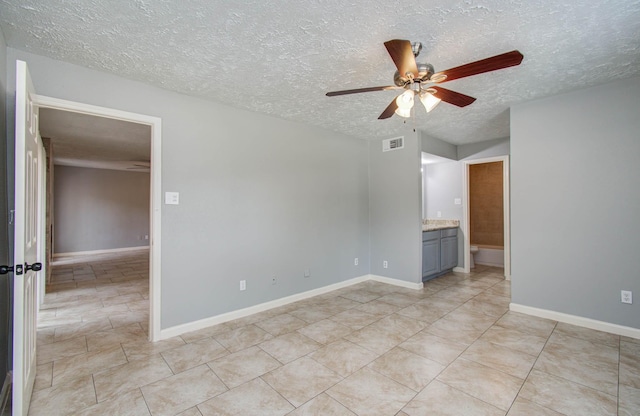 10555 Turtlewood Ct Unit 2802, Houston, TX 77072 - unfurnished room featuring a textured ceiling, ceiling fan, and light tile patterned floors