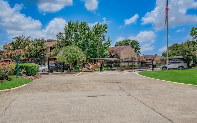 10555 Turtlewood Ct Unit 2802, Houston, TX 77072 - view of concrete road with a gate, a gated entry, and curbs