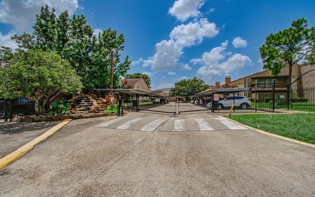 10555 Turtlewood Ct Unit 2802, Houston, TX 77072 - view of concrete road featuring a gate and a gated entry