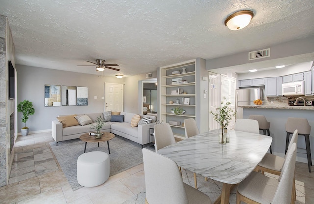10555 Turtlewood Ct Unit 2802, Houston, TX 77072 - dining room featuring ceiling fan and a textured ceiling