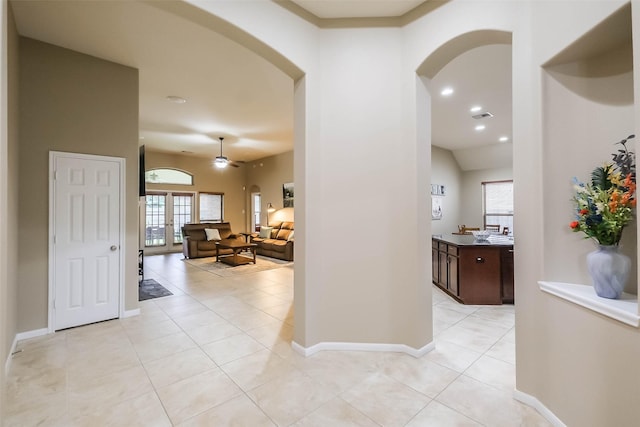 4507 Cinco Forest Trl, Katy, TX 77494 - hall with arched walkways, light tile patterned flooring, and recessed lighting