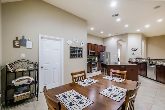 4507 Cinco Forest Trl, Katy, TX 77494 - dining room featuring arched walkways, light tile patterned floors, and recessed lighting
