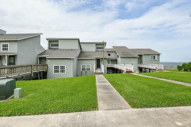 325 Carolcrest Ln Unit 3, Livingston, TX 77351 - view of front of property with a front yard, a deck with water view, and roof with shingles