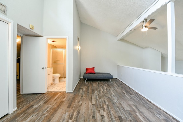 325 Carolcrest Ln Unit 3, Livingston, TX 77351 - sitting room with a ceiling fan, wood finished floors, a textured ceiling, and high vaulted ceiling