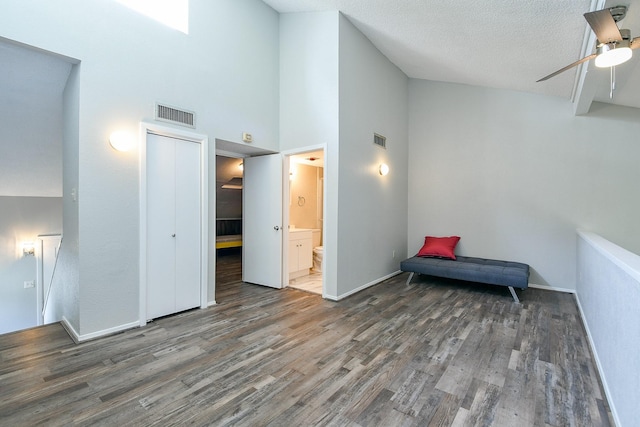 325 Carolcrest Ln Unit 3, Livingston, TX 77351 - living area with wood finished floors, a ceiling fan, a towering ceiling, and a textured ceiling