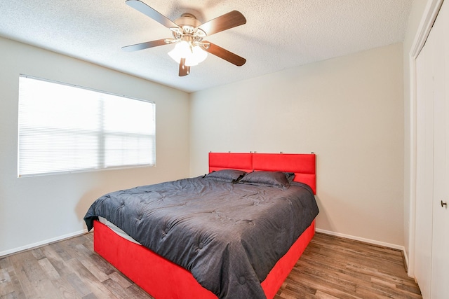 325 Carolcrest Ln Unit 3, Livingston, TX 77351 - bedroom with wood finished floors, a closet, a textured ceiling, and ceiling fan