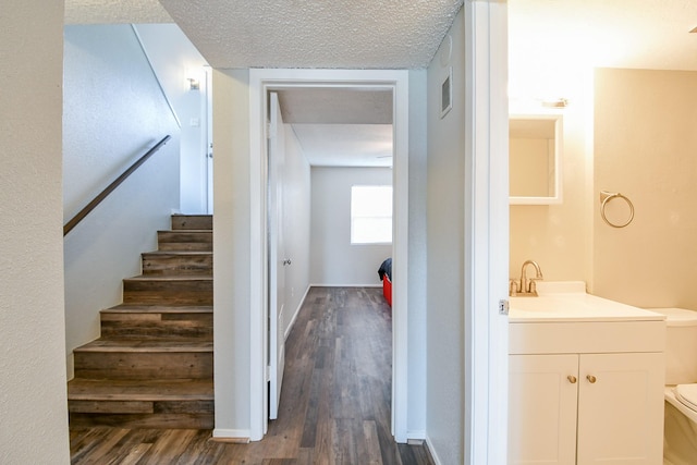 325 Carolcrest Ln Unit 3, Livingston, TX 77351 - stairway featuring wood finished floors and a textured ceiling