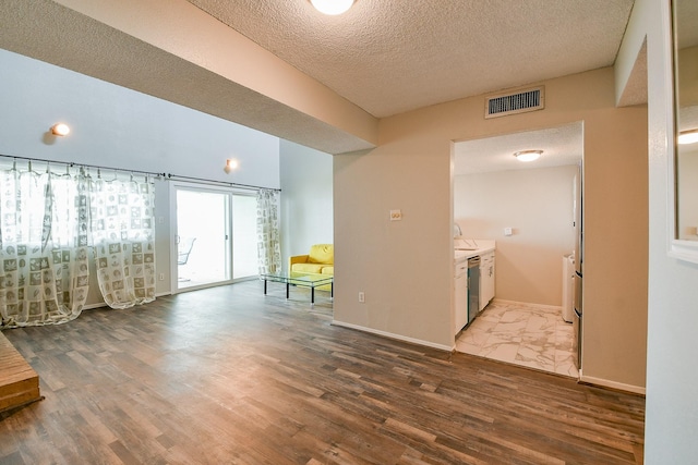 325 Carolcrest Ln Unit 3, Livingston, TX 77351 - living room featuring wood finished floors and a textured ceiling