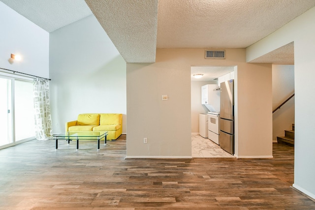 325 Carolcrest Ln Unit 3, Livingston, TX 77351 - unfurnished room with a textured ceiling, light wood-type flooring, and stairway