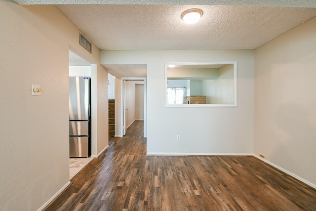 325 Carolcrest Ln Unit 3, Livingston, TX 77351 - spare room with wood finished floors and a textured ceiling