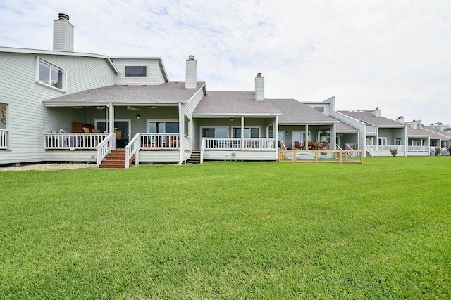 325 Carolcrest Ln Unit 3, Livingston, TX 77351 - rear view of property featuring a yard, roof with shingles, a chimney, a ceiling fan, and a deck
