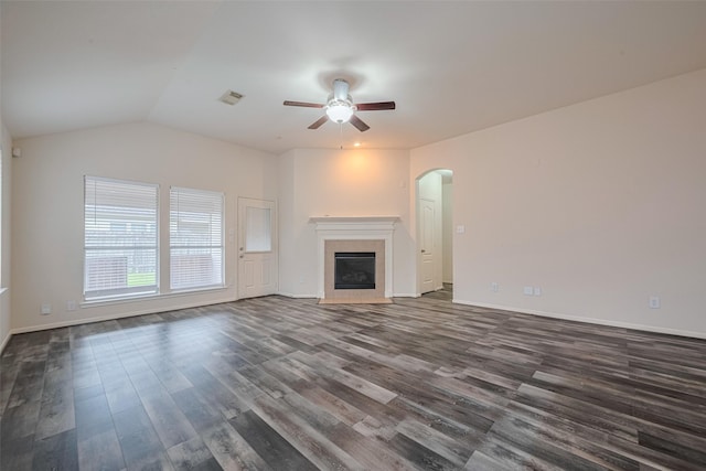 5515 Brookhollow Pines Ct, Houston, TX 77084 - unfurnished living room featuring a ceiling fan, dark wood-style floors, arched walkways, a tile fireplace, and lofted ceiling