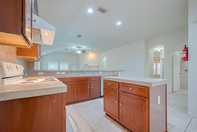 5515 Brookhollow Pines Ct, Houston, TX 77084 - kitchen with arched walkways, range, a ceiling fan, light countertops, and lofted ceiling