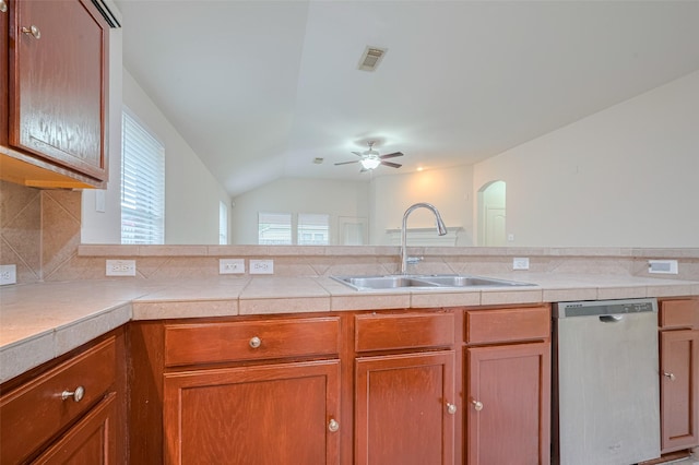 5515 Brookhollow Pines Ct, Houston, TX 77084 - kitchen featuring stainless steel dishwasher, ceiling fan, arched walkways, backsplash, and vaulted ceiling