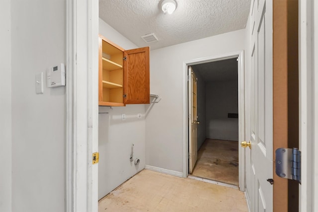 5723 Painted Trail Dr, Houston, TX 77084 - washroom featuring a textured ceiling and baseboards