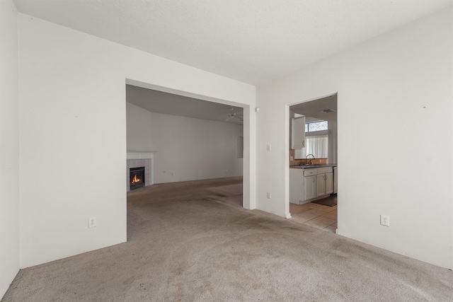 5723 Painted Trail Dr, Houston, TX 77084 - carpeted spare room with a fireplace and a sink